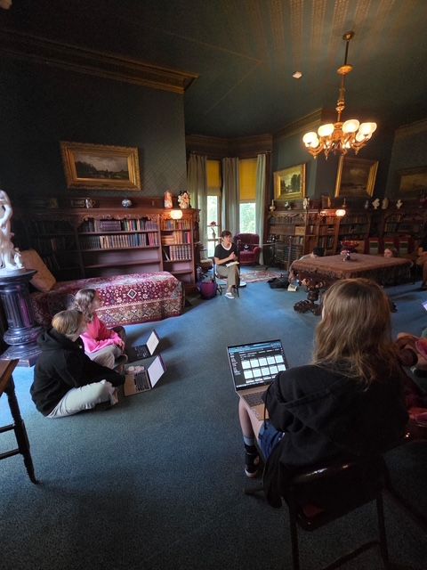 Author Andrea Ezerins posing with her book at the Nook Farm Voices program at the Mark Twain House in Hartford, CT.