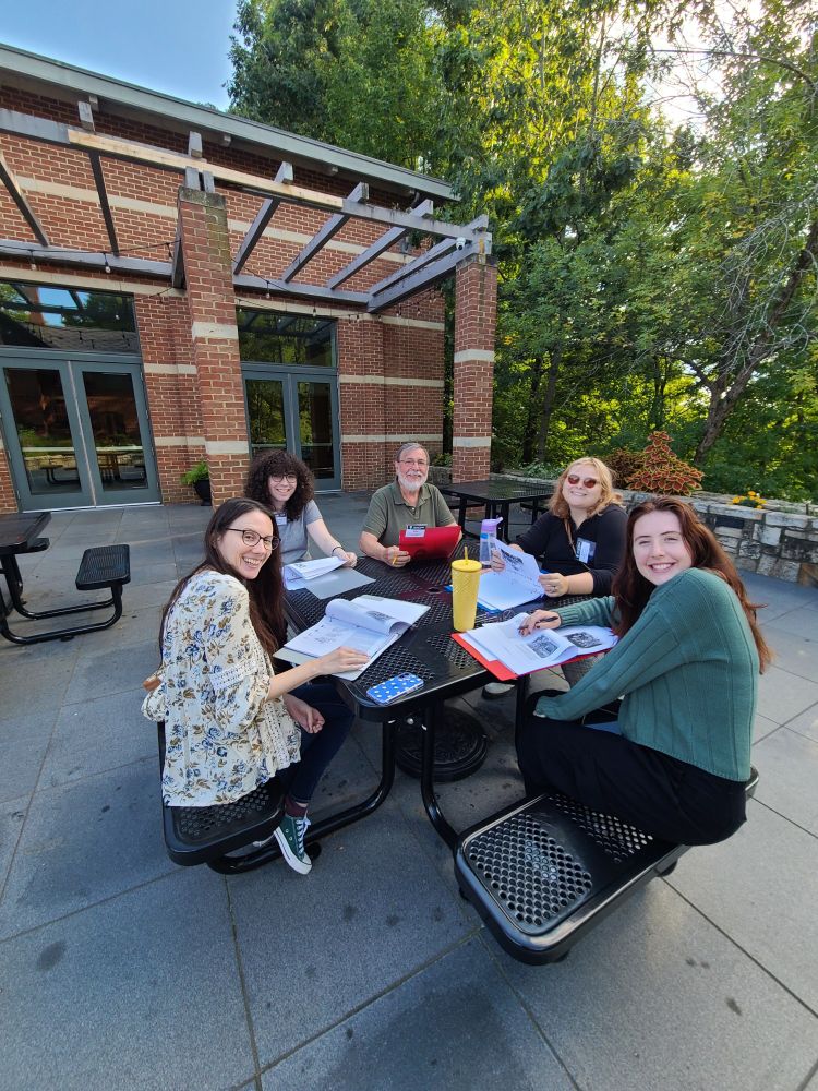 A group of new tour guides posing on the patio of the Mark Twain House Museum in Hartford, CT.
