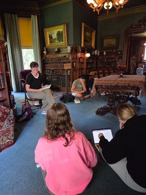 Author Andrea Ezerins posing with her book at the Nook Farm Voices program at the Mark Twain House in Hartford, CT.