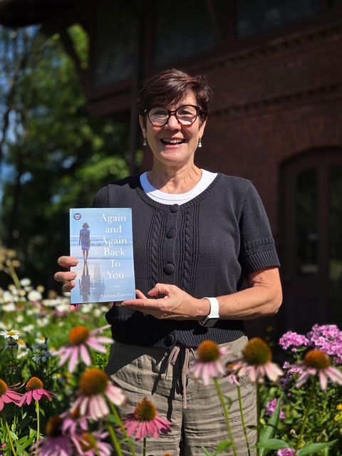 Author Andrea Ezerins posing with her book at the Nook Farm Voices program at the Mark Twain House in Hartford, CT.