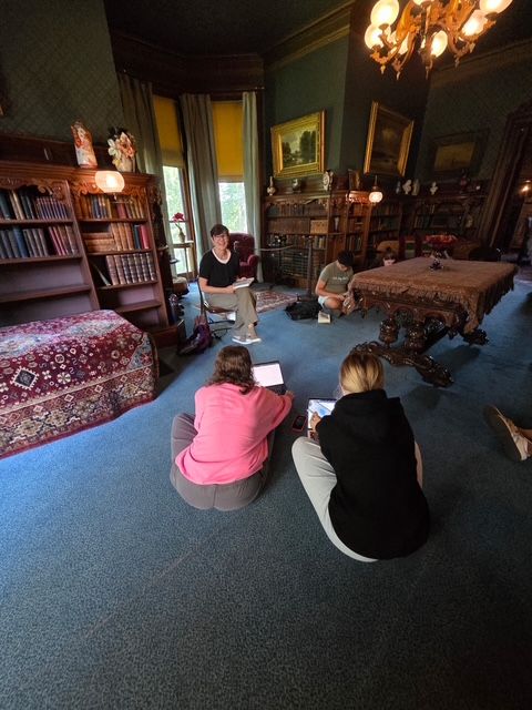 Author Andrea Ezerins posing with her book at the Nook Farm Voices program at the Mark Twain House in Hartford, CT.