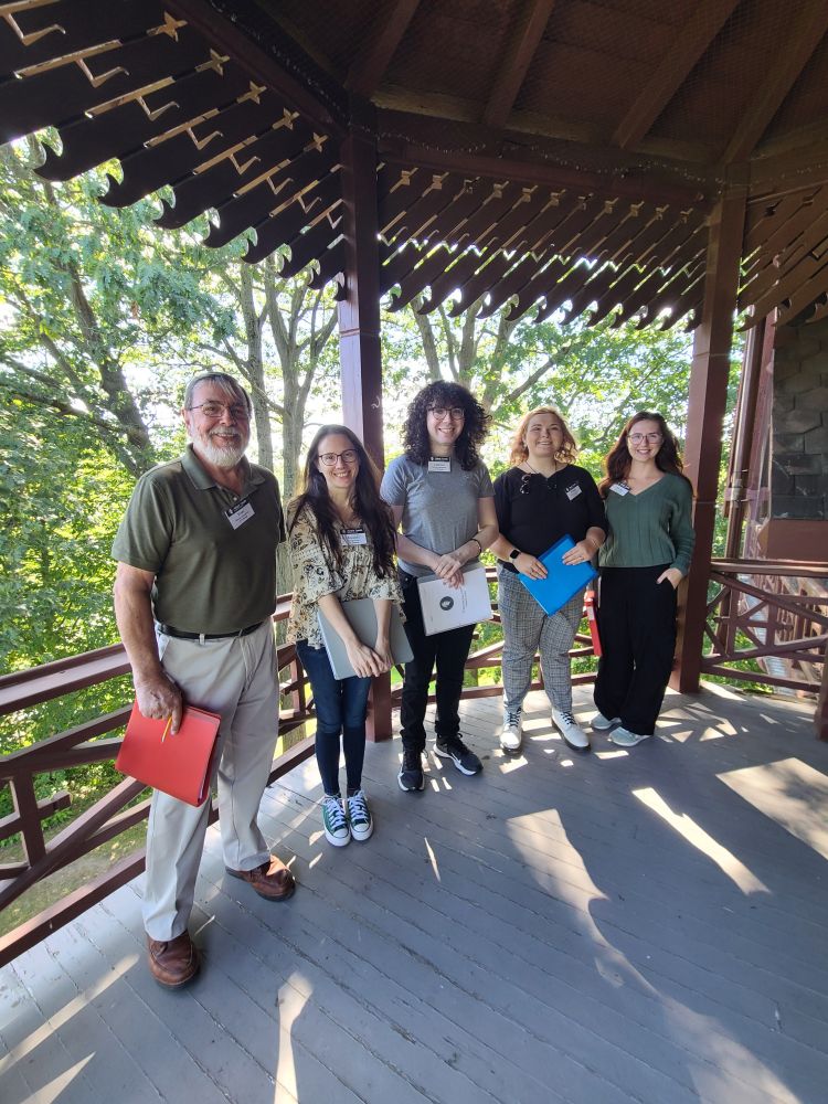 A group of new tour guides posing on the deck of the Mark Twain House in Hartford, CT.