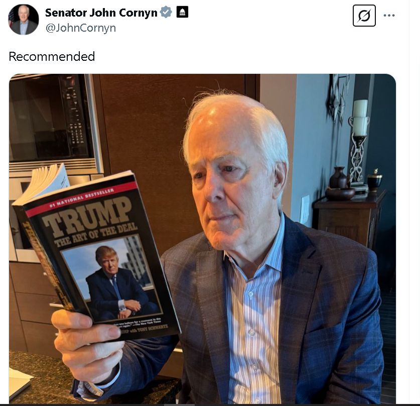 A tweet by Sen John Cornyn recommending Trump's "The Art of the Deal", showing a picture of him reading it avidly.
