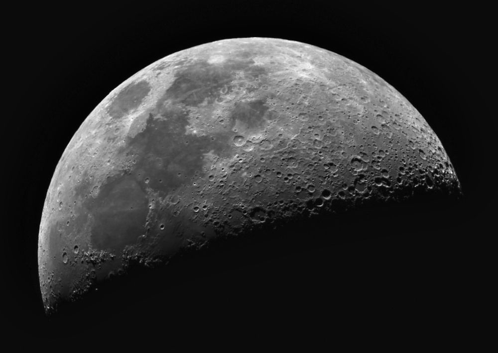 A first quarter moon showing well defined craters along the terminator.