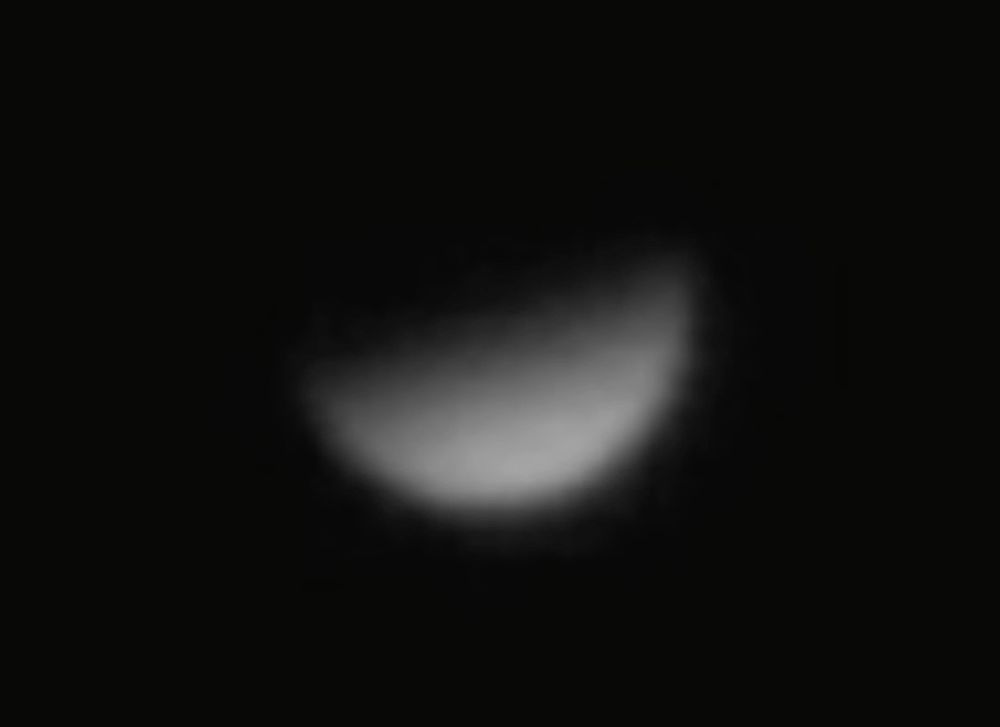 A close up photograph of the planet Venus during Dichotomy. Venus appears like a capital letter D because from Earth at this time it appears perfectly half-illuminated by the Sun. 