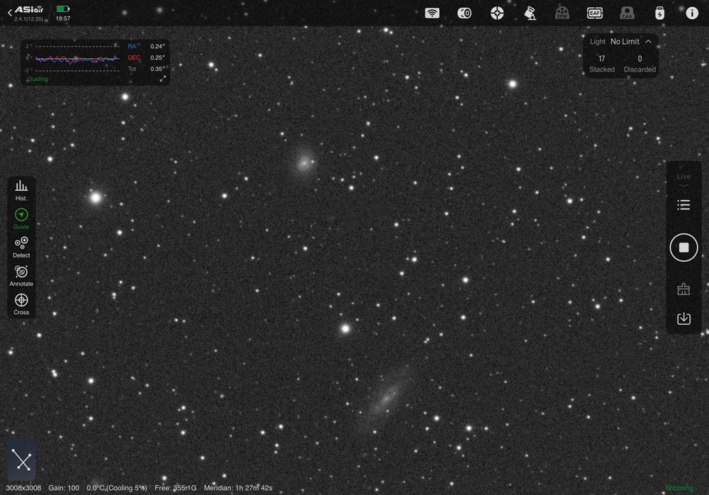 A photograph of a star field that includes two small faint galaxies. The smaller galaxy can just be resolved as a face-on spiral with a supernova (bright star) to the right of its galactic core. 