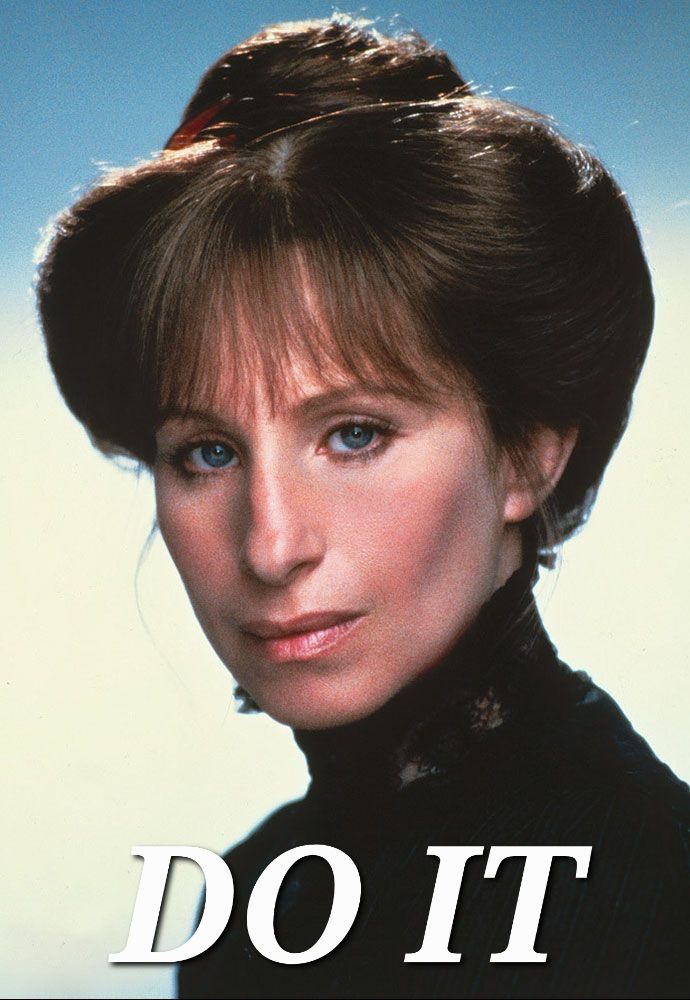 A portrait of Barbra Streisand, 40 at the time, in her femme-presenting costume from Yentl. She's staring intensely into the camera. The picture is captioned, 