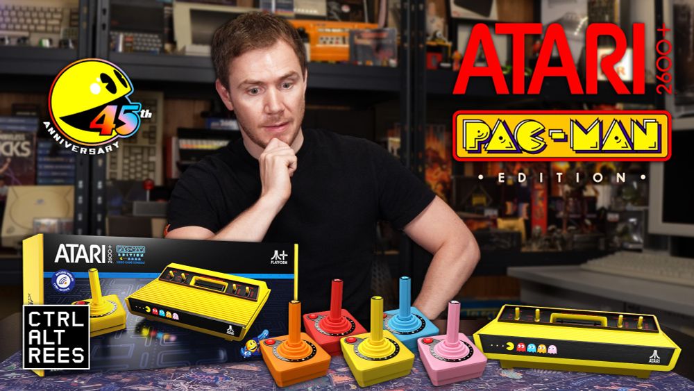 A very handsome man looks confused and somewhat surprised at the array of poorly Photoshopped items on his desk.