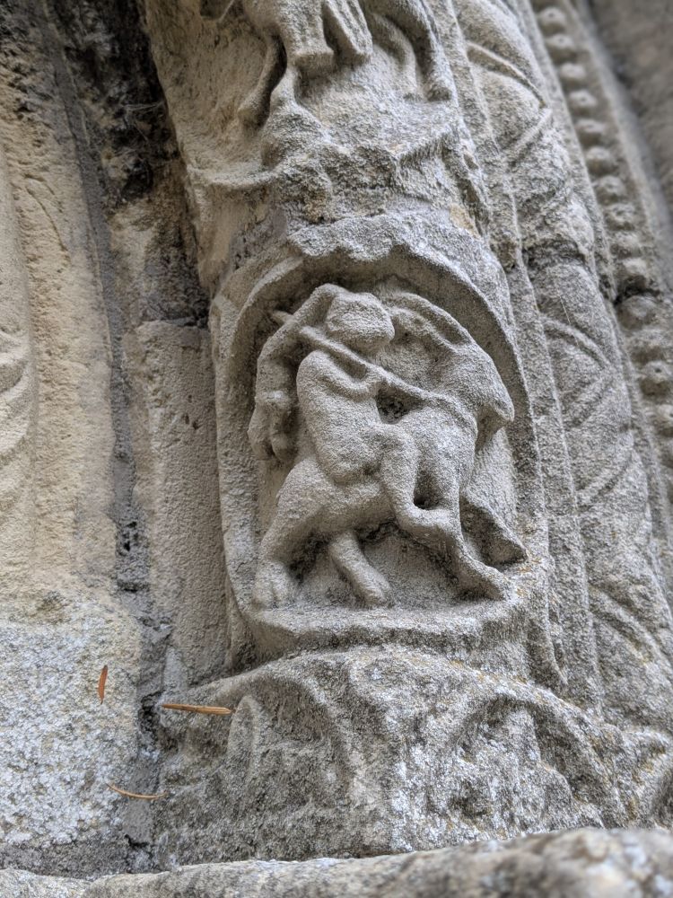 Detail from the southern door at St. Nicholas Church, Barfrestone. A rabbit riding a goat?