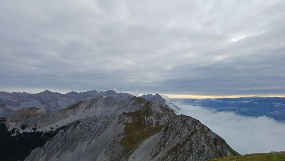 The alpine mountain ridge north of Innsbruck, AT above the clouds in the valley