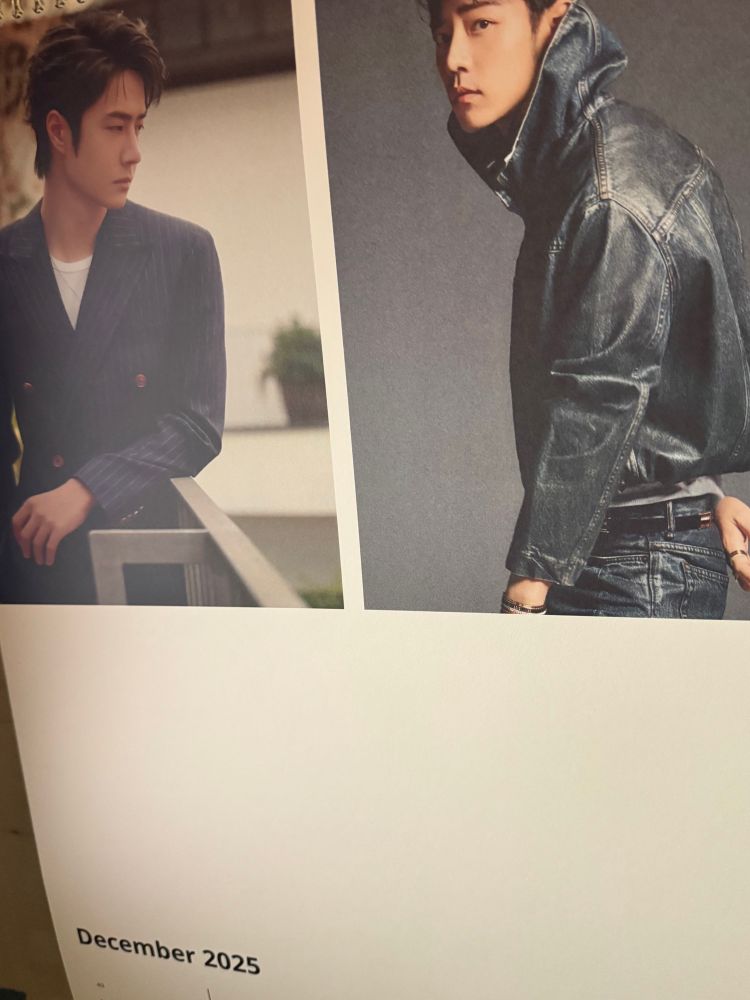 An A3 calendar showing December 2025 with a picture of Wang Yibo, left, and Xiao Zhan, right. They’re not looking at each other but they are turned toward each other. Sigh. 