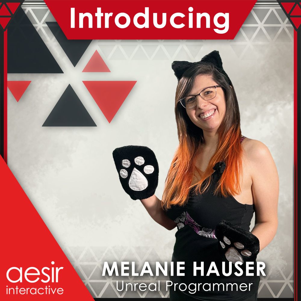 Image of an employee smiling into the camera, standing 45 degrees, and wearing cat ears and cat gloves. They are surrounded by a graphic banner which says "Introducing", "Melanie Hauser", "Unreal Programmer", and "Aesir Interactive".