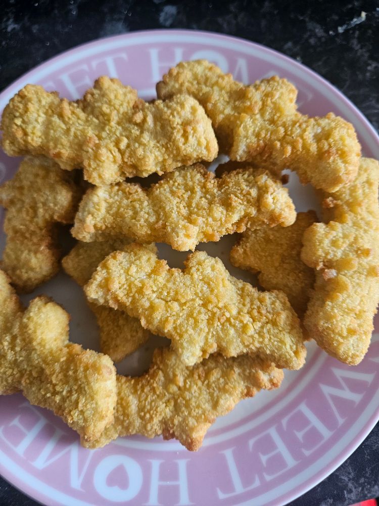 bat shaped chicken shapes on a white and pink side plate 