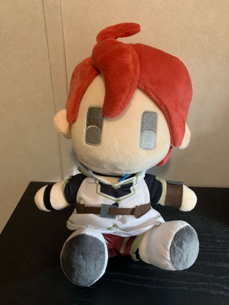 Photo taken of a plushie of Adol Christin from the game Ys X Nordics