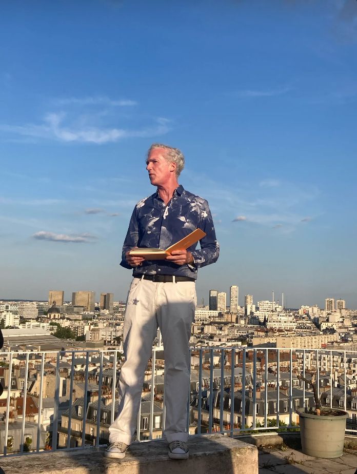 Poet Jason Stoneking reads from his Sky Sketches series on a rooftop overlooking Paris