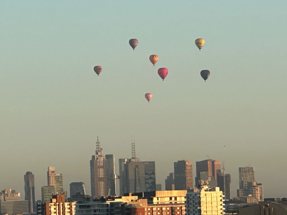 7 colourful hot air balloons, high in the sky, on a beautiful, crisp, Spring morning just after sunrise.