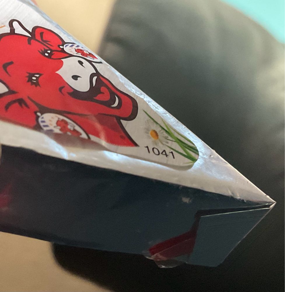 A little triangle of cheese in foil, with a red tab to pull and tear away the wrapper. 