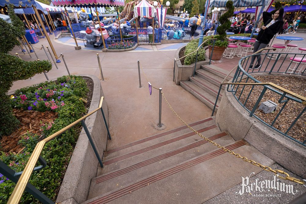 Photograph of two small staircases between Casey Jr. Circus Train and Dumbo the Flying Elephant in Fantasyland at Disneyland.