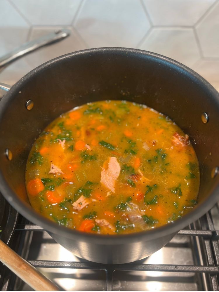 Mid-stage soup with turkey wings deboned and kale added to the broth.