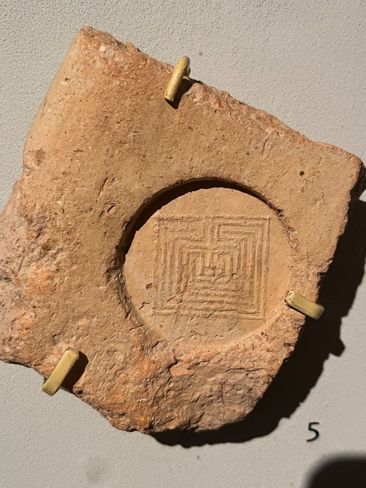 Tile which has been stamped with an image of the labyrinth