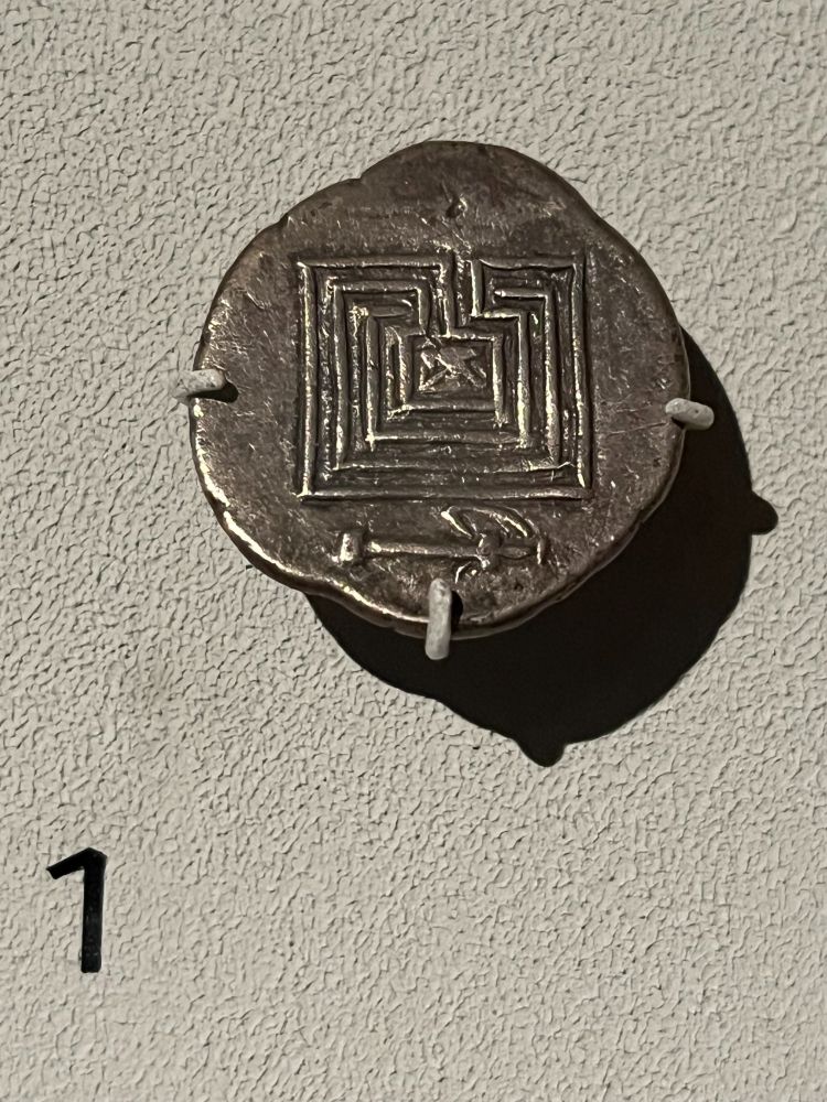 Silver coin with an image of the labyrinth, which has a tiny (and rather indistinct) image of the minotaur at the centre