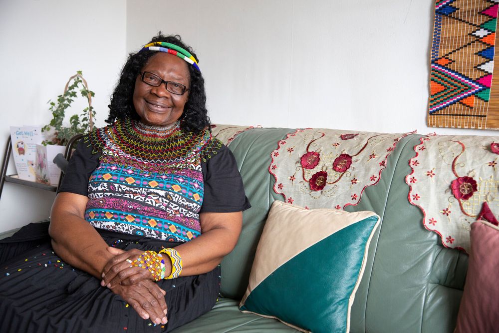 Older woman on a sofa smiling