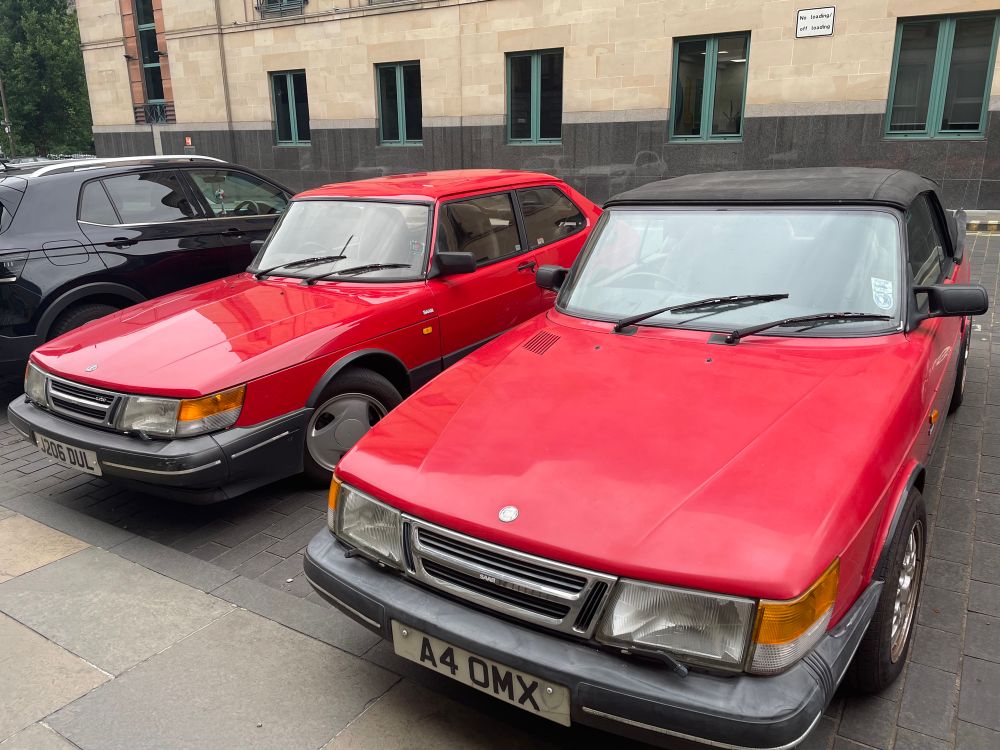 Two Drive My Car cars side by side (Red SAAB turbos)