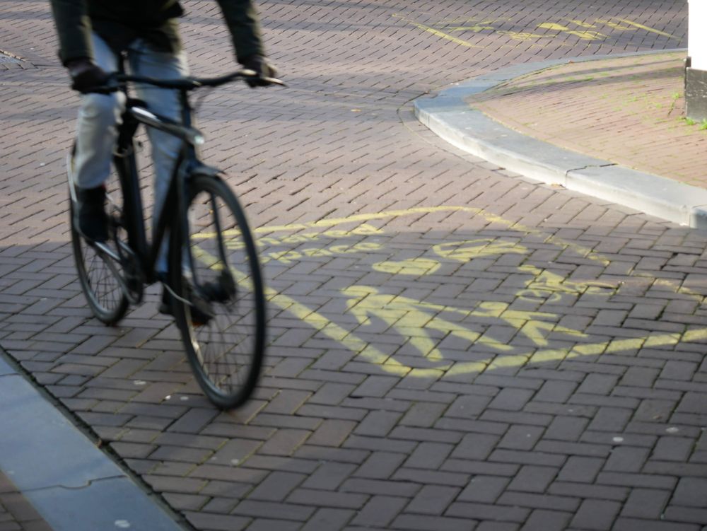 Bicycle in Amsterdam on a shared space sign. Photo by me.