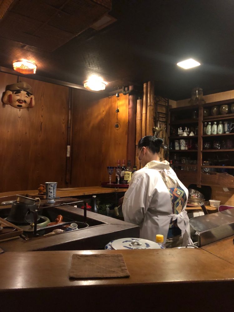 Junko-san prepares food in the small Japanese restaurant. It is Showa style inside, with space for only 6 customers at the counter. 