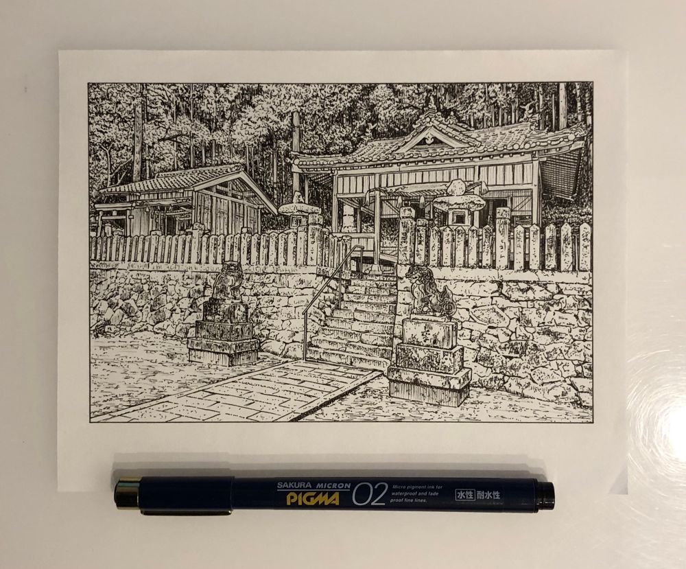 An illustration on paper showing a stone path with stone lion statues on each side, leading to stone steps. At the top of the steps is a long stone fence, behind it are two wooden buildings with traditional Japanese clay tile roofs, these are old Shinto shrines. Large trees fill out the background of the illustration. A pen is below the drawing to show the size.