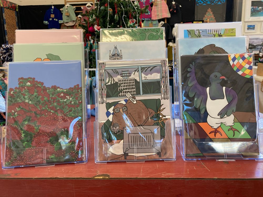 Three display racks with Elisabeth Witbrock’s A4 art prints from her Absurbirdies and Focus on Florals series. 