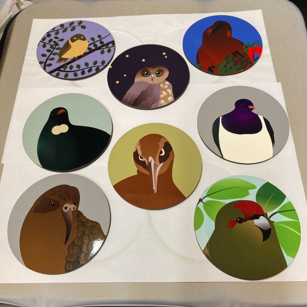 8 round coasters printed with illustrations of native bird head and shoulders (and the whole of a tauhou, ‘cos they’re so bitty).