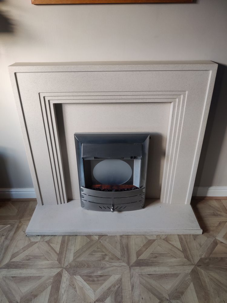 A tired plastic fire surround and electric fire. Surround in beige in colour. Fire is silver and looks so dated. I've hated it all these years I've been in this house. 