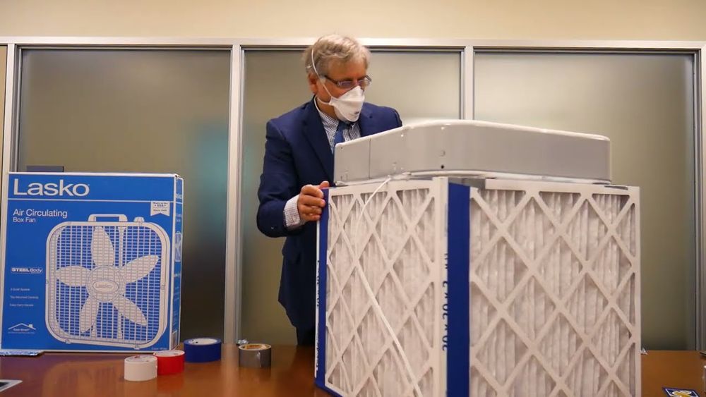 Corsi stands with DIY air purifier as he builds it