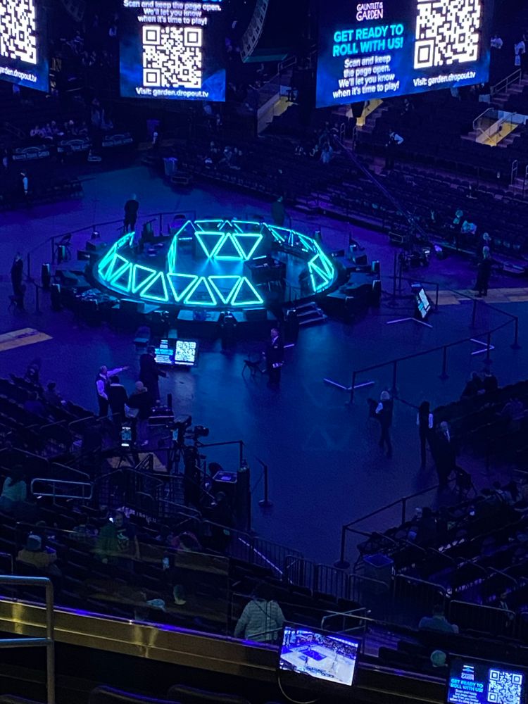 A picture of the stage for Dimension 20 Live: Gauntlet at the Garden. It's set up in a circle mimicking the famous D20 Dome and it's situated on "center ice" at Madison Square Garden.
