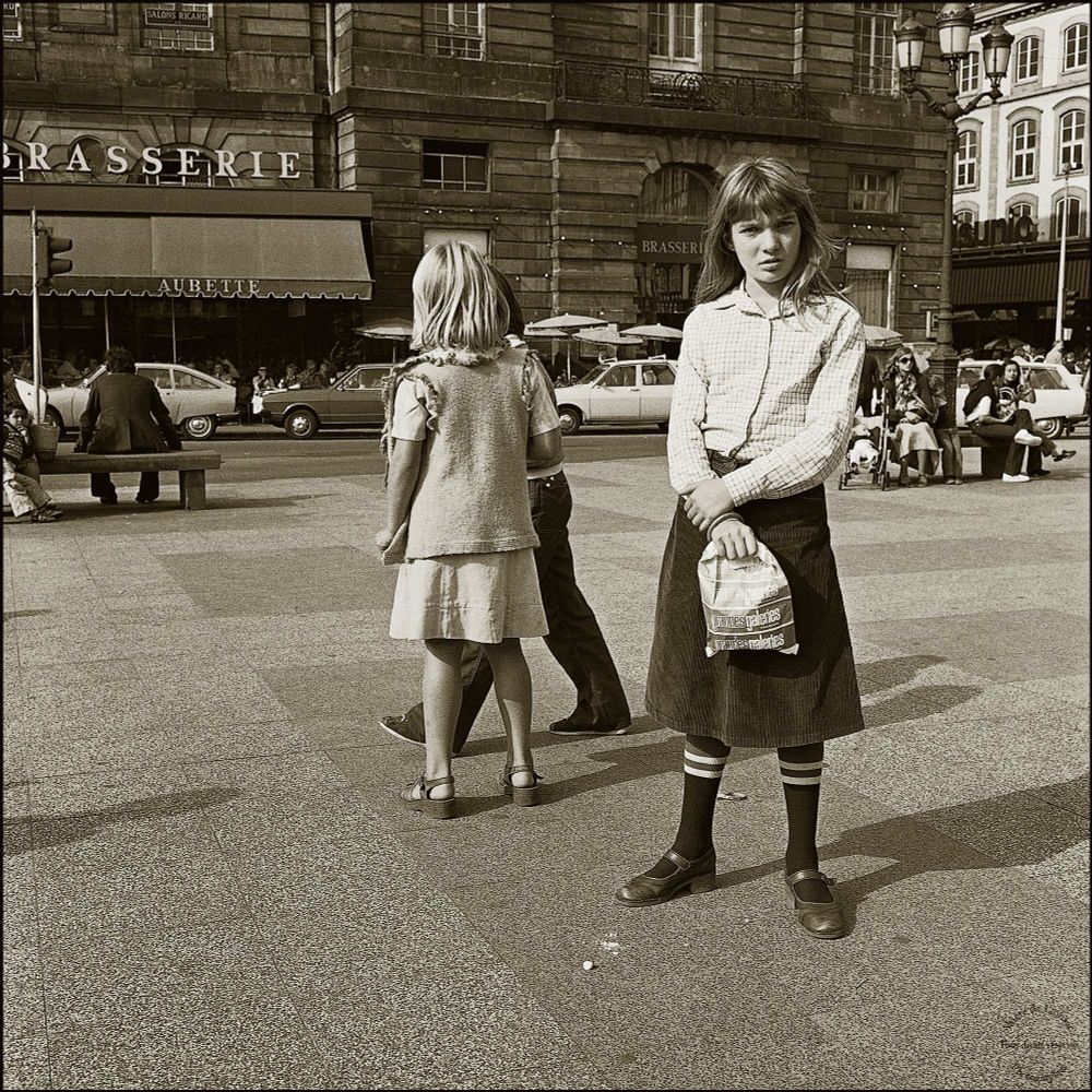 Children at play on a city square.

Digitally toned film black and white photograph.