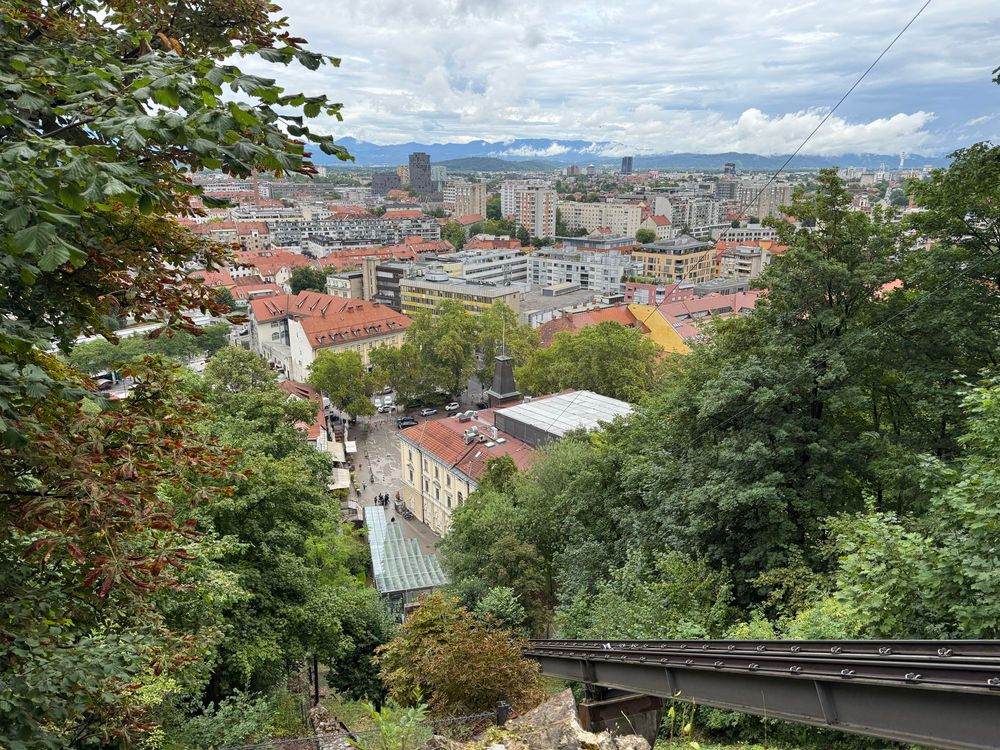 View of Ljubljana city from a viewpoint on the walk down from the castle - the city to castle funicular track can be seen in the foreground