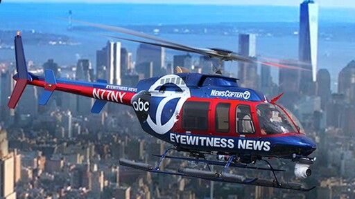 Side view of an ABC7 news helicopter over the chicago skyline
