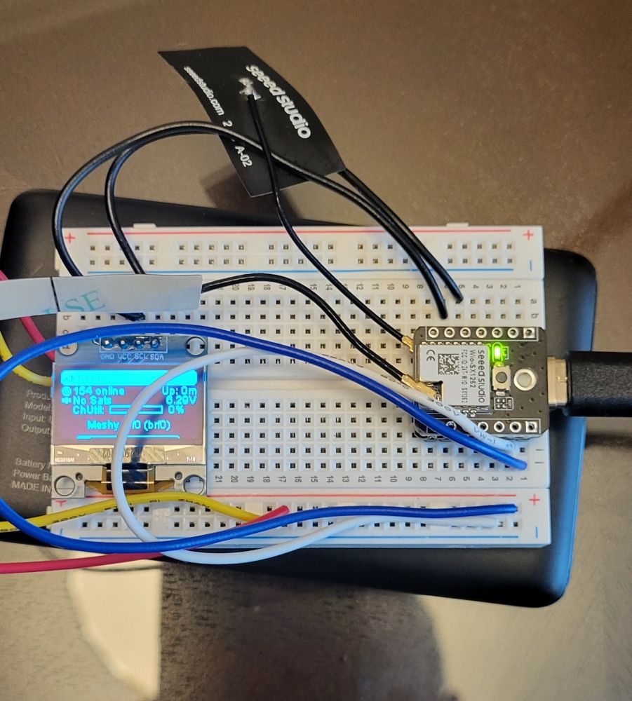 Breadboard with esp32s3 mcu and lora snap in and small oled screen