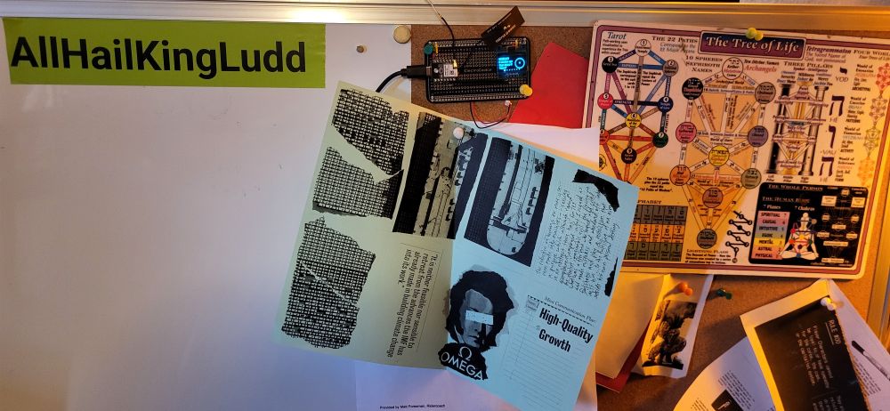 Meshtastic device on a prototyping board pinned to a cork board