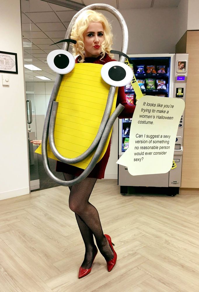 Woman dressed as "Clippy" with caption, "It looks like you trying to make a women's Halloween costume.

Can I suggest a sexy version of something no reasonable person would ever consider sexy?"