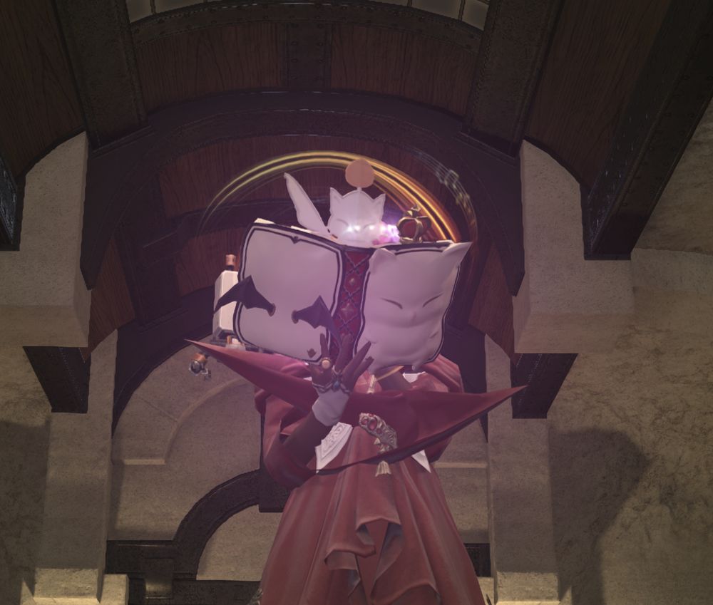 A dark-skinned elf is reading a book shaped like a Moogle. Her long draping sleeves are sticking out rigidly from her elbows.