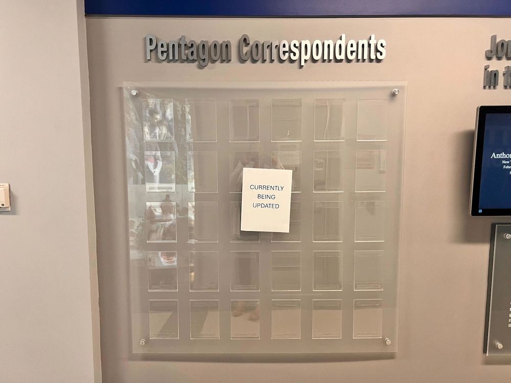 In the Pentagon press room, there’s a wall of photographs under metal lettering that reads “Pentagon Correspondents” with the faces of the men and women who cover the Defense Department for the major news outlets.
On Friday, all 30 slots for photographs were empty.