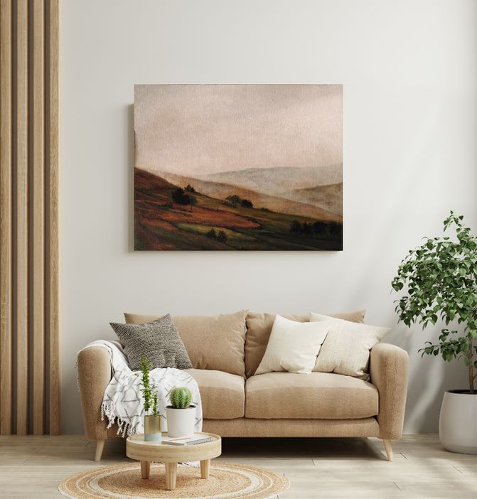 Moody oil painting with warm hues and foogy atmosphere is styled on a neutral wall with a couch and plants besides in a living room scene 