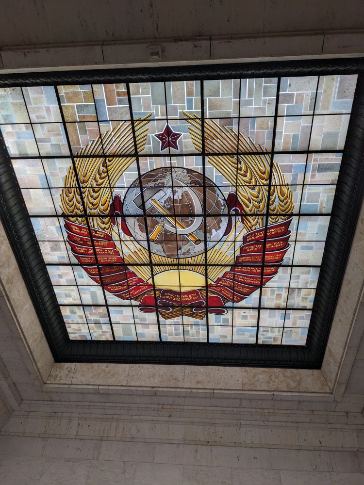 A colourful ceiling mosaic featuring the Soviet Union hammer and sickle.