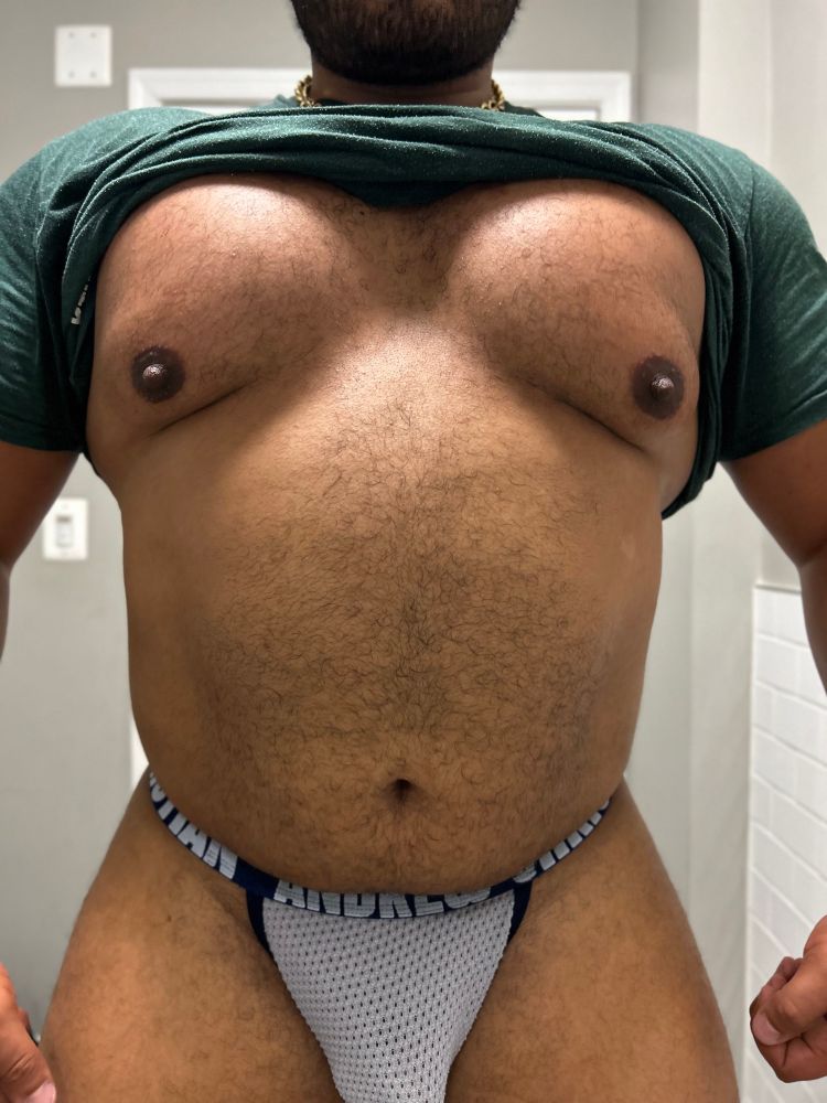 A shot of a big and muscular guys torso, he is wearing some underwear with a mesh fabric, he is pulling his shirt over his torso so you can see the belly and nipples 