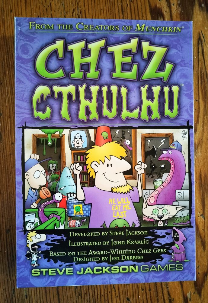 Purple box with "Chez Cthulhu" in bright green lettering above a picture of a crowded room with various people, animals, and things in it. At the bottom are game credits and, in that same green, "Steve Jackson Games."