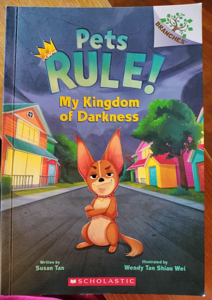 Chapter book called PETS RULE! MY KINGDOM OF DARKNESS, written by Susan Tan & illustrated by Wendy Tan Shiau Wei. Cover shows a Chihuahua in the middle of a residential street, smirking. The dog is standing on its hind legs, with its "arms" folded across its chest.