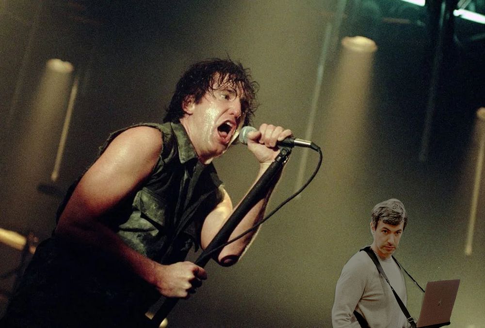 Trent Reznor onstage screaming into a microphone while Nathan Fielder, holding his laptop, stares creepily.