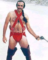 Sean conner as Zardoz wearing red speedo and suspenders and black thigh high boots.